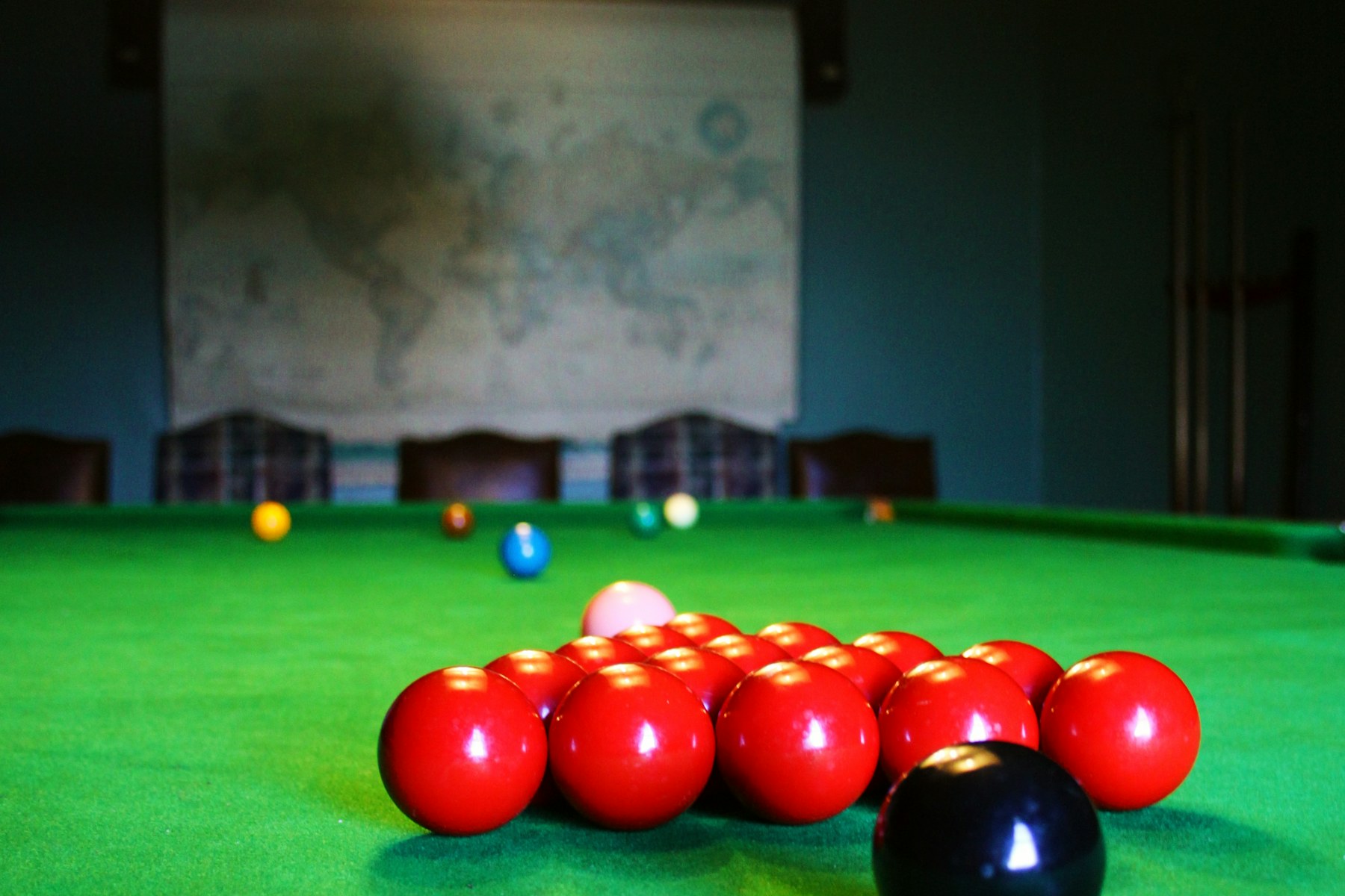 A full-size snooker table correctly set with fifteen reds, six colours and the cue ball.